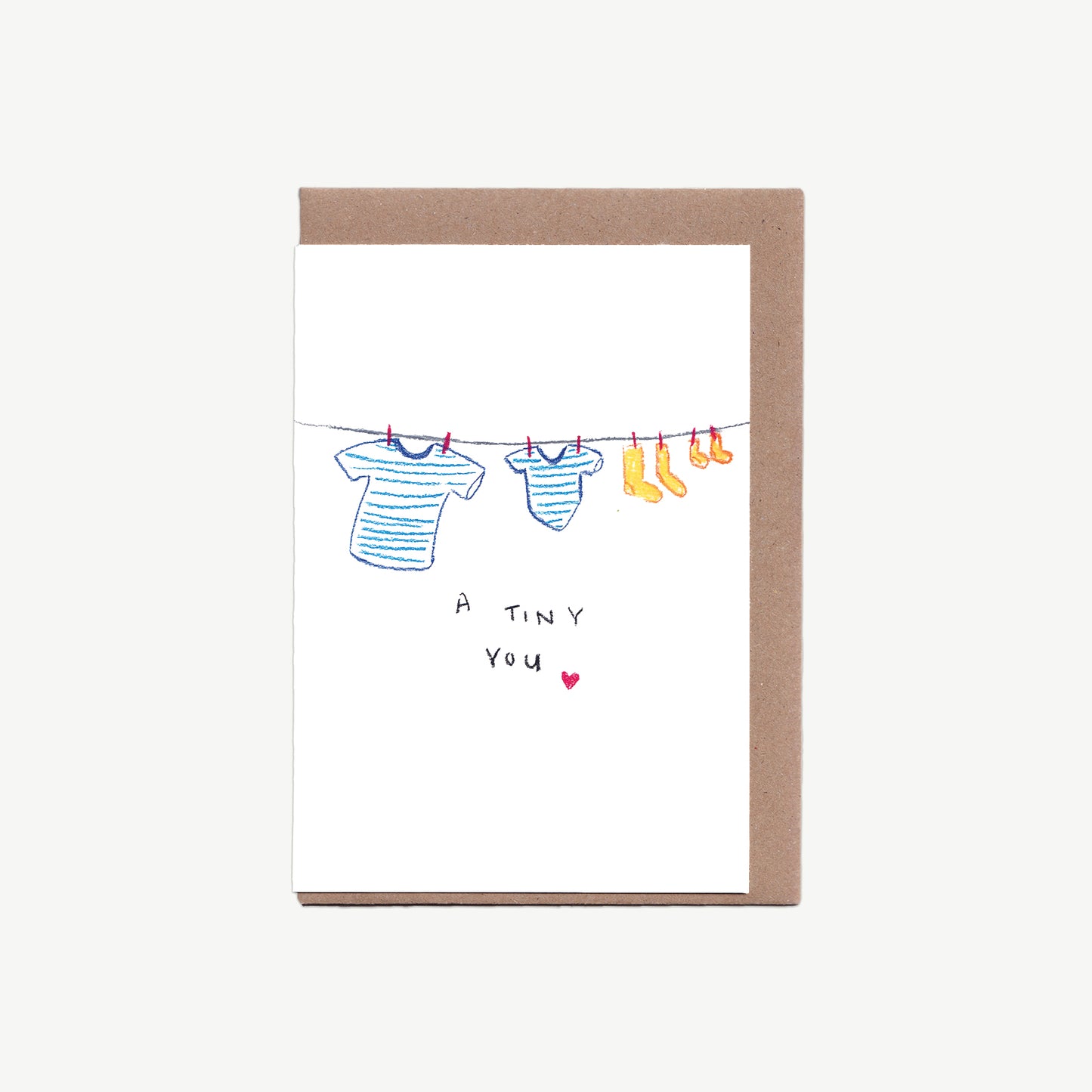 A Greetings Card with a washing line, little and large blue striped t-shirts and little and large yellow socks with the words 'a tiny you' and a heart, drawn in pastel pencil