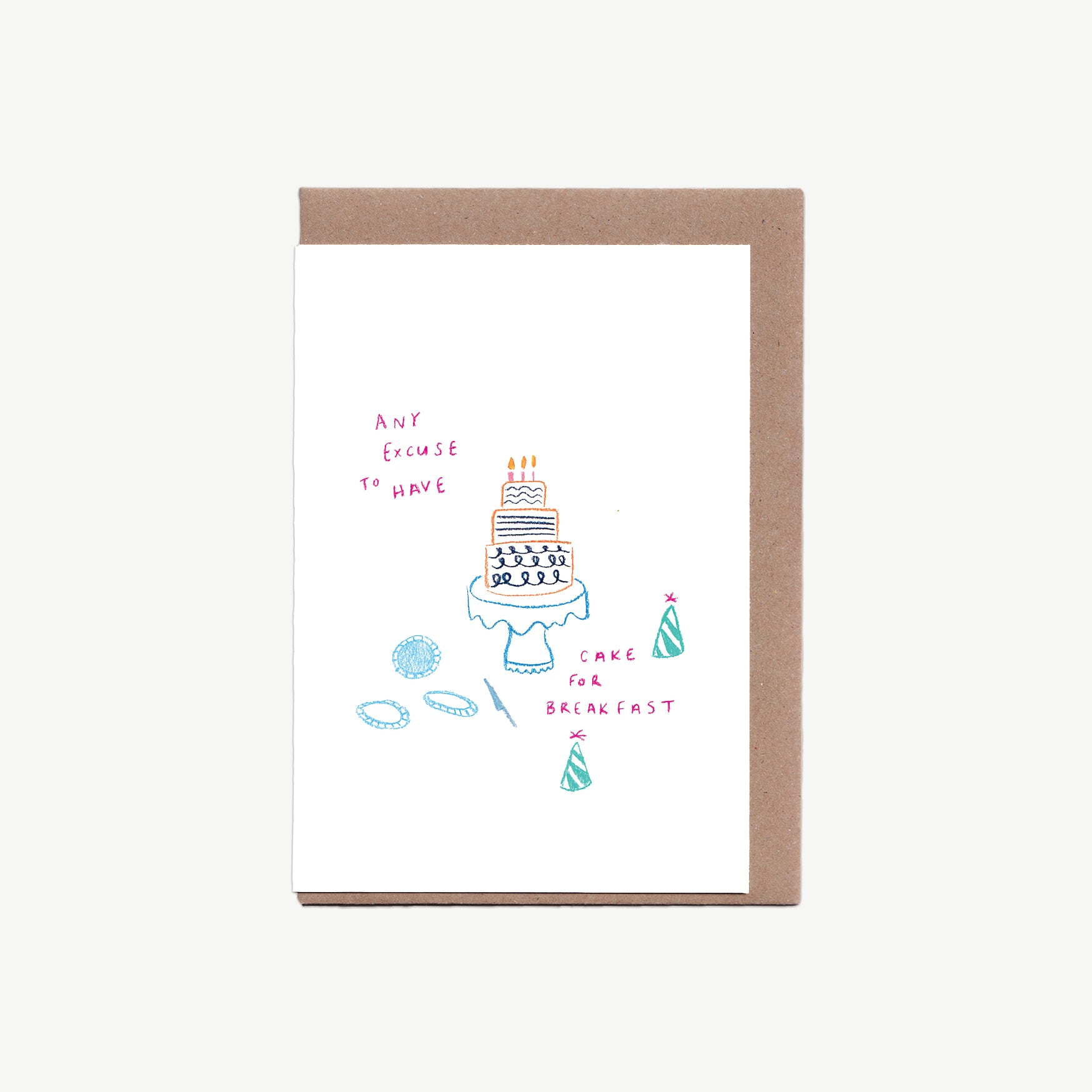 A Greetings card with a birthday cake on a cake stand, with party hats and plates, the words 'any excuse to have cake for breakfast' written in pink pencil