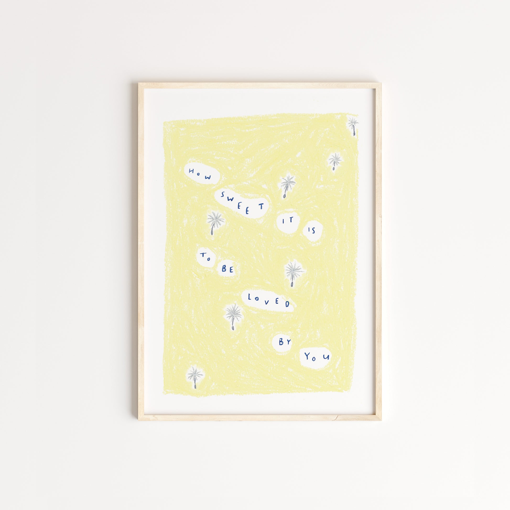 Illustrated print of dandelion seeds floating through the air, along with the words 'how sweet it is to be loved by you' written in dark blue with a yellow background, drawn in pastel pencil. Displayed in an oak frame