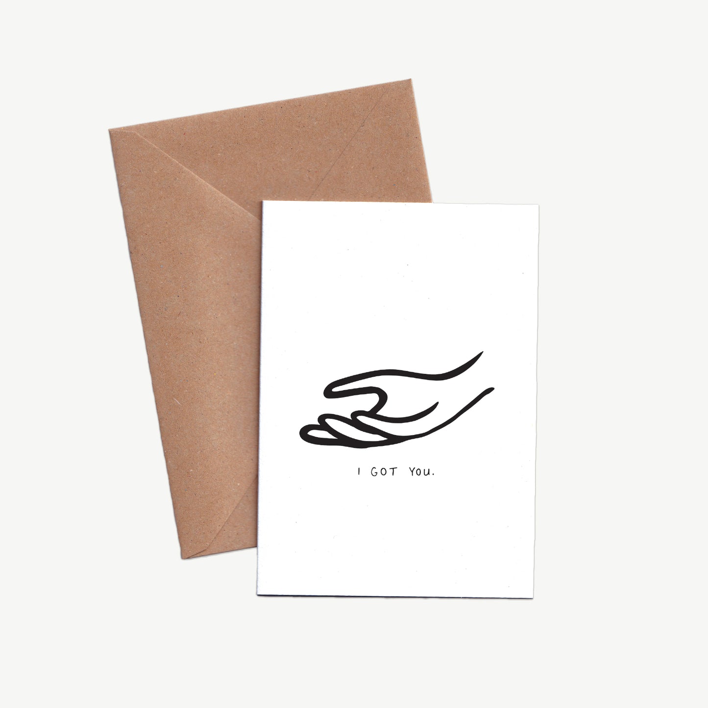 A Sympathy Card designed in simple black lines of an offering hand with the words I got you written underneath. Displayed with a kraft envelope