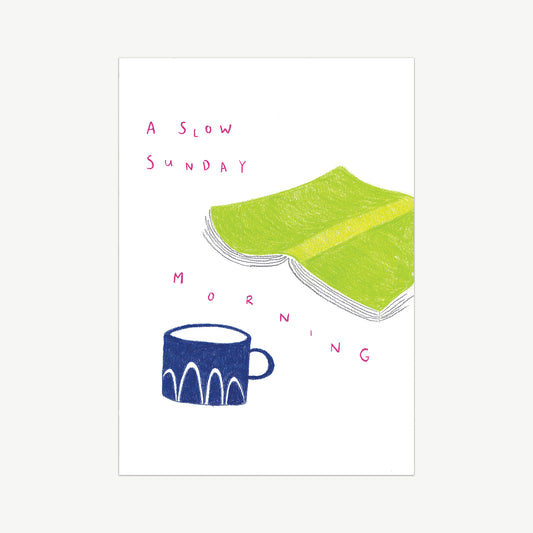 Handdrawn with pencil wall art, featuring a green book laid flat and a blue mug. The words A Slow Sunday written in pink across a white background