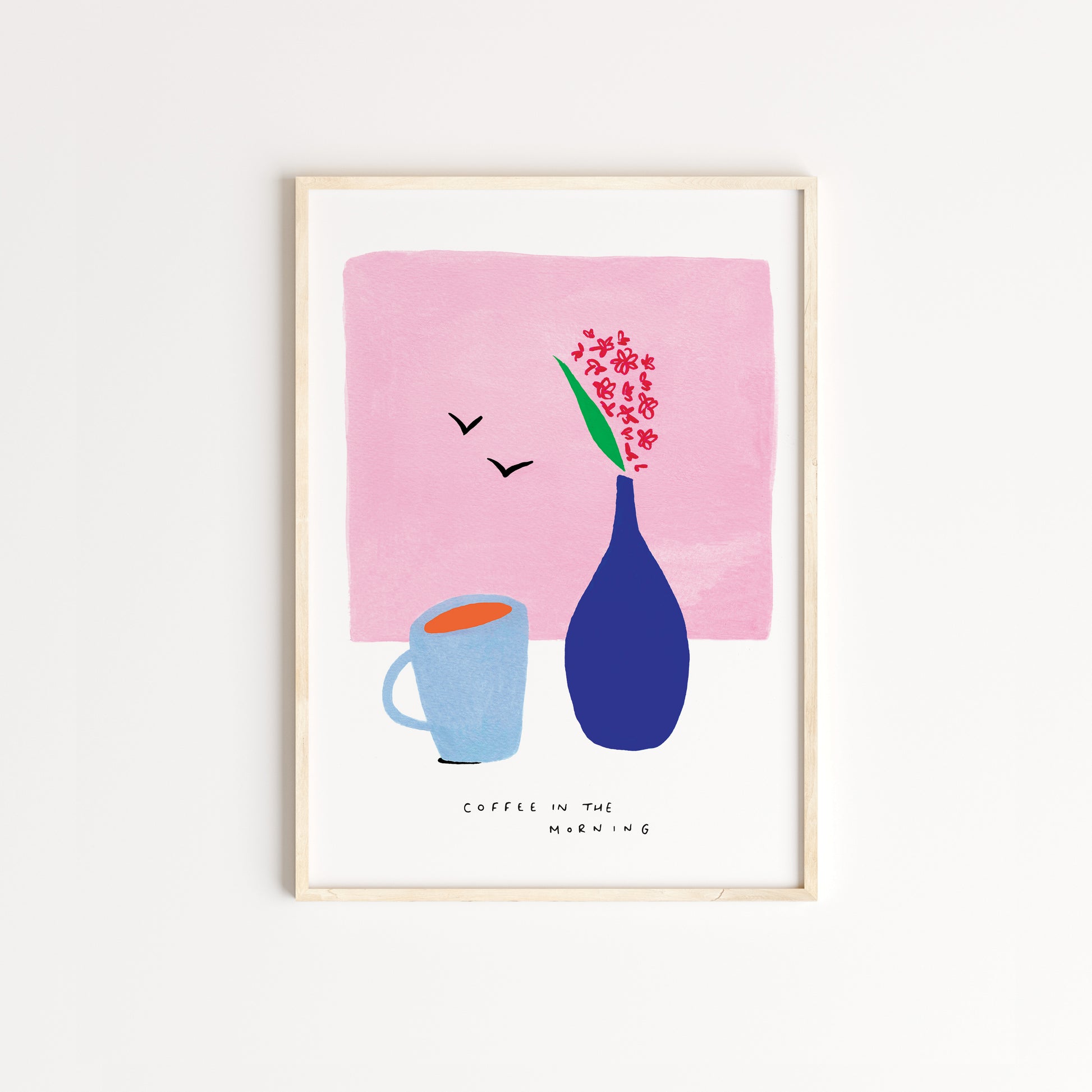 Handdrawn using gouache paint and pens. A grey coffee mug beside a dark blue vase with red flowers on a light pink background. The words 'coffee in the morning' written across the bottom of the artwork in fine black pen. Captured in an oak frame.