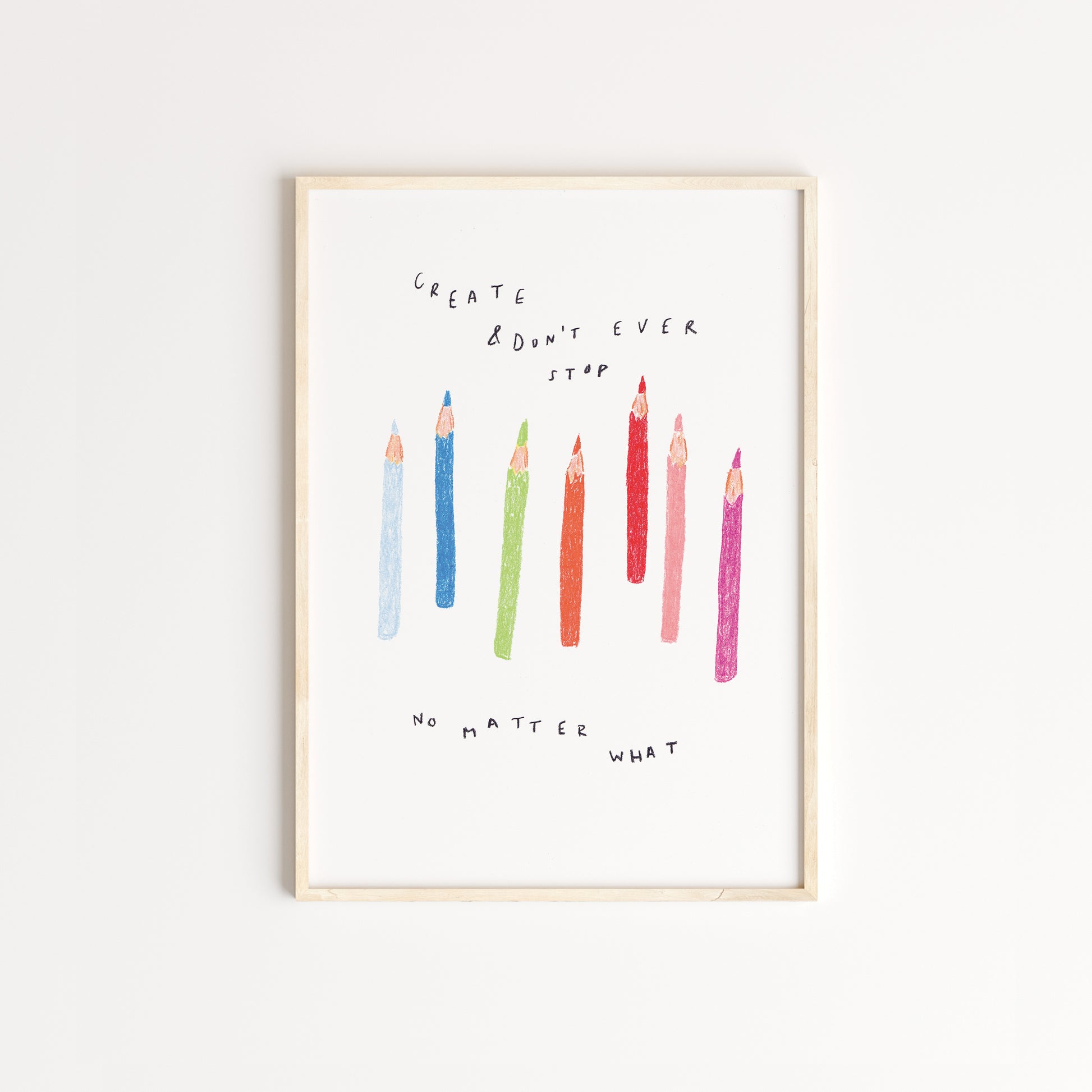 Handdrawn using pencils - a set of coloured pencils, resembling the pattern of rainbow alongside the words 'create & don't stop no matter what' captured in oak frame