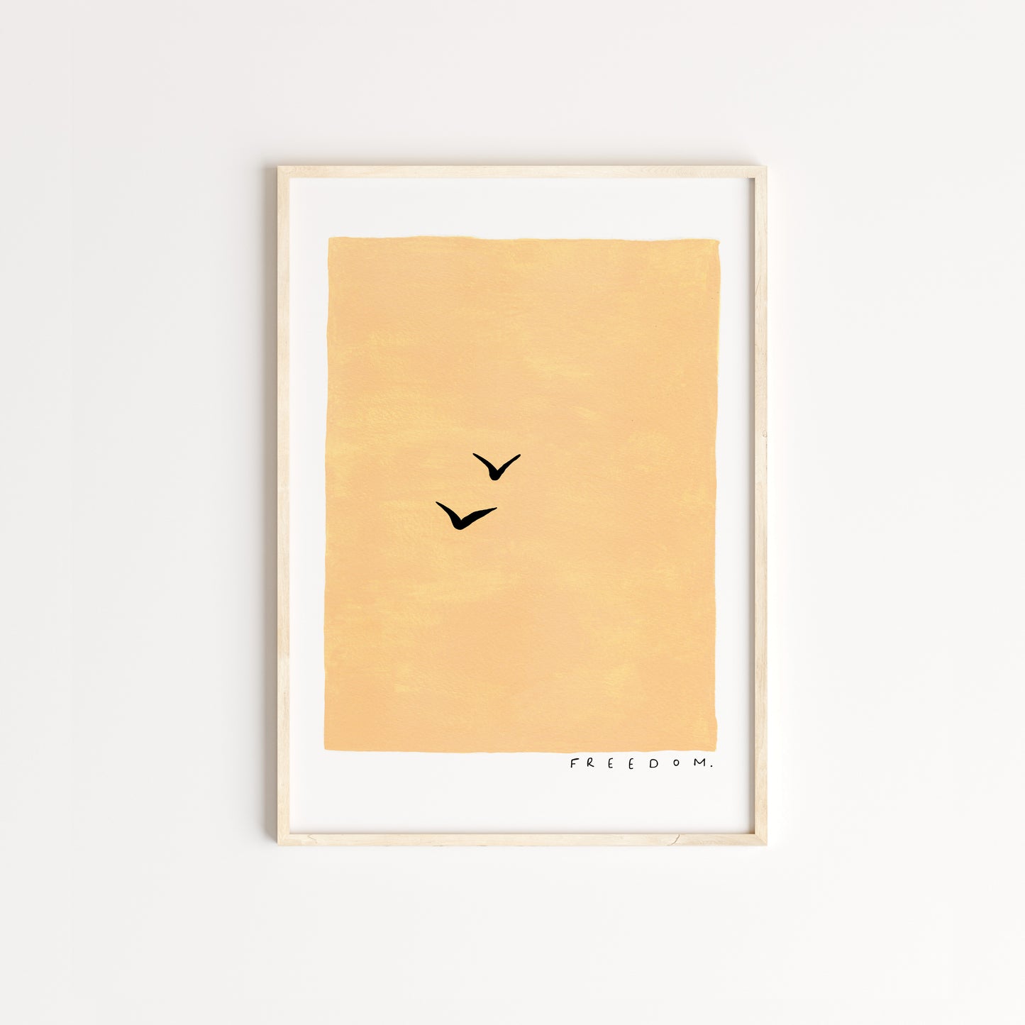 Handpainted warm yellow background with two silhouettes of birds across the page. The word 'freedom' written in the bottom right in black pen. Captured in an oak frame