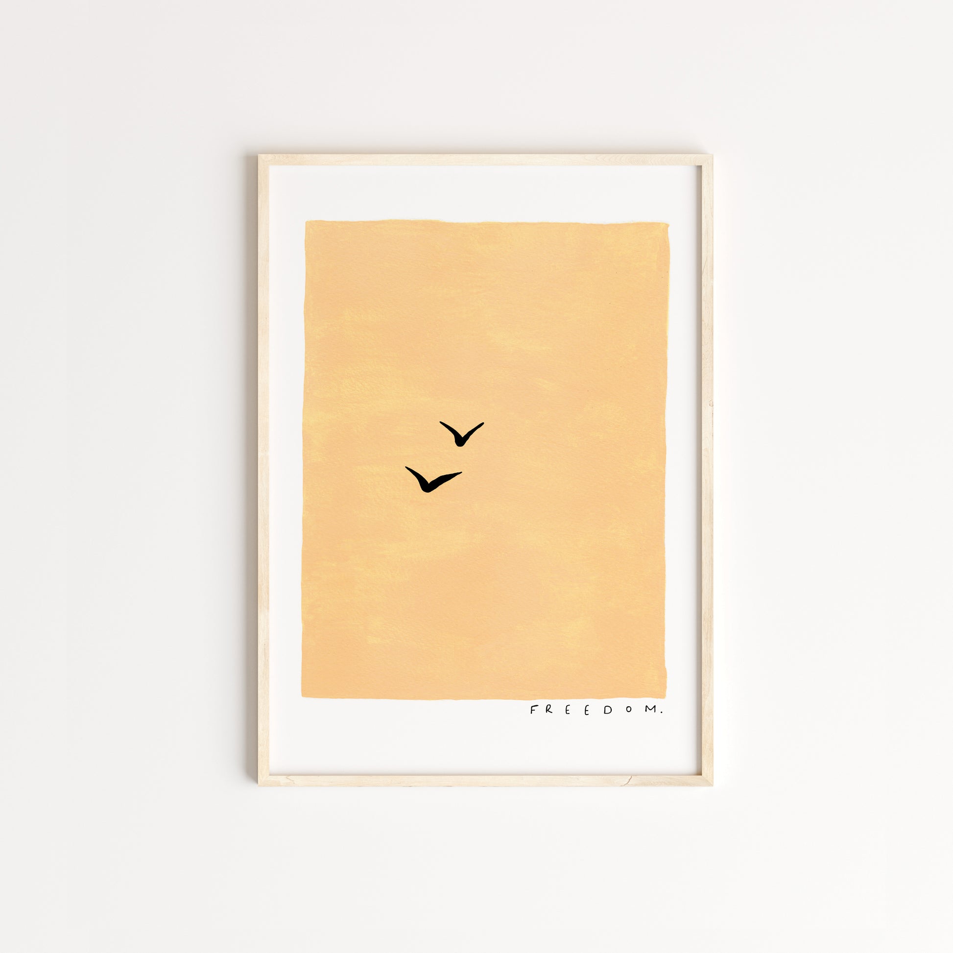 Handpainted warm yellow background with two silhouettes of birds across the page. The word 'freedom' written in the bottom right in black pen. Captured in an oak frame